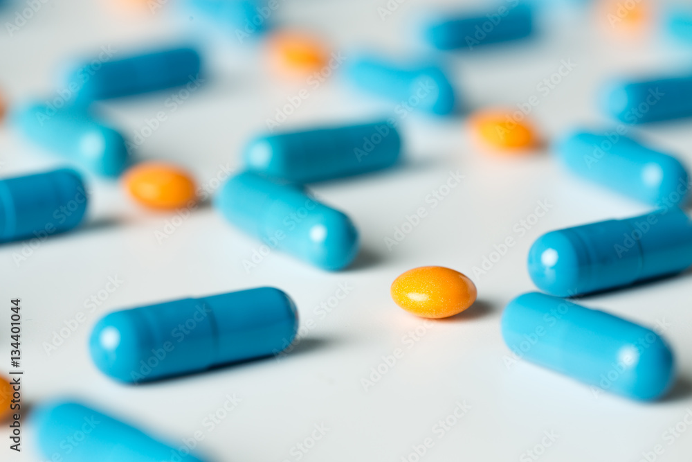 Blue medical pills and capsules pattern on white background. flat lay, top view.