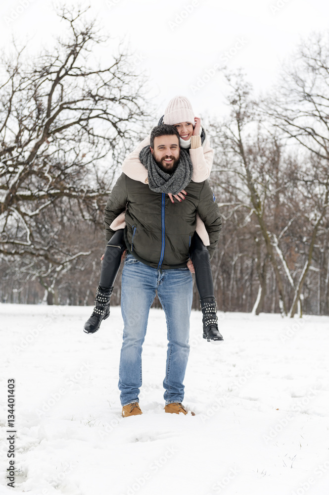 Loving couple enjoying the snow in the park Loving couple enjoying the snow in the park