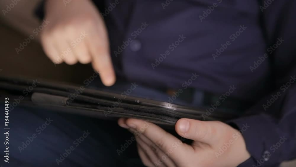 Boy playing on a tablet.Full hd video Boy playing on a tablet.Full hd video