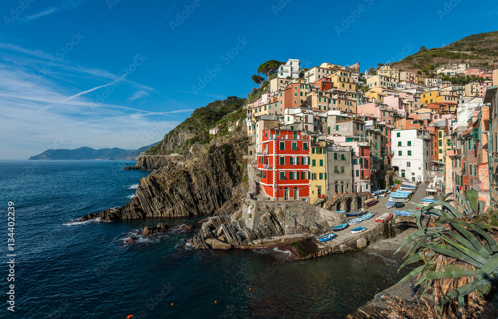 Houses on rocks near sea bay of Riomaggiore town in Cinque Terre national park, Italy