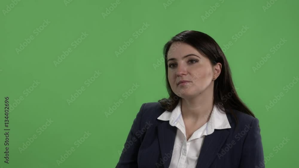 Woman having job interview or other serious conversation against green screen Woman having job interview or other serious conversation against green screen