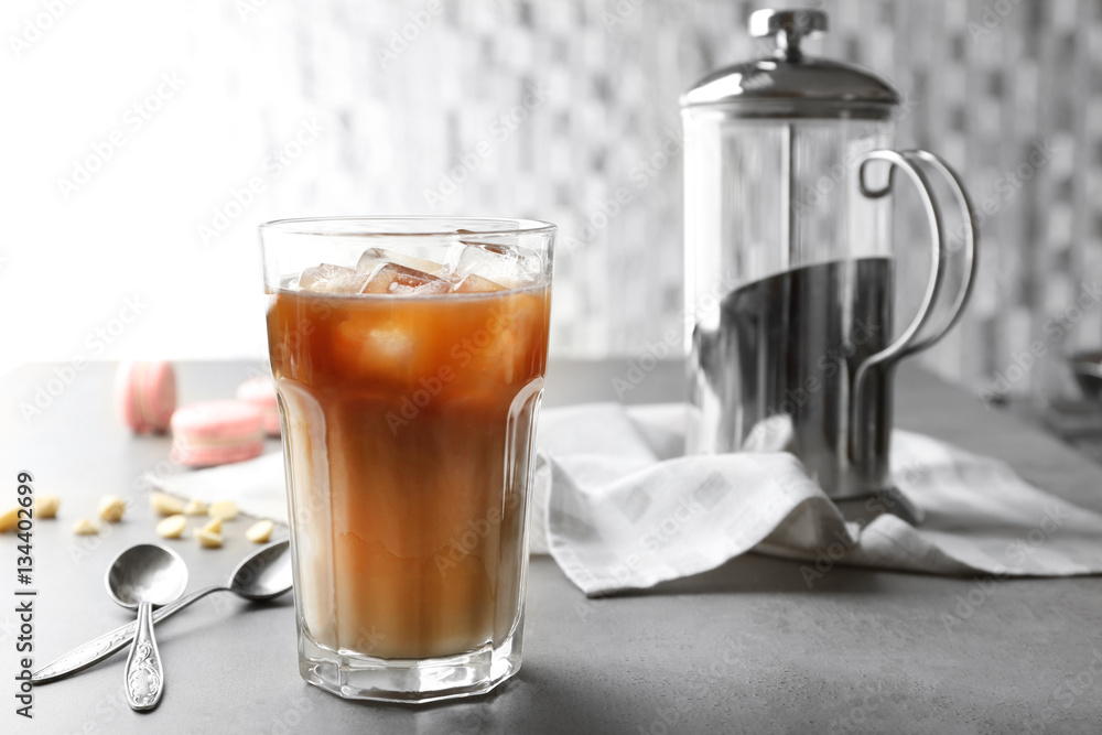 Glass of cold coffee with spoons on table Glass of cold coffee with spoons on table