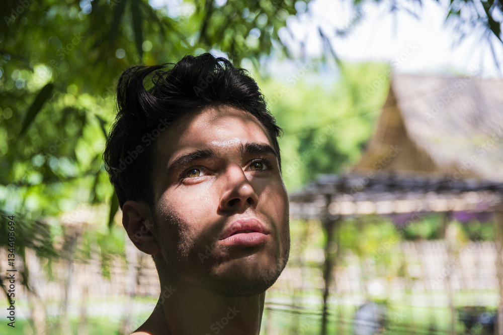 Handsome young man outdoors in city park