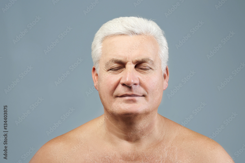 Obraz premium Portrait of senior man on grey background