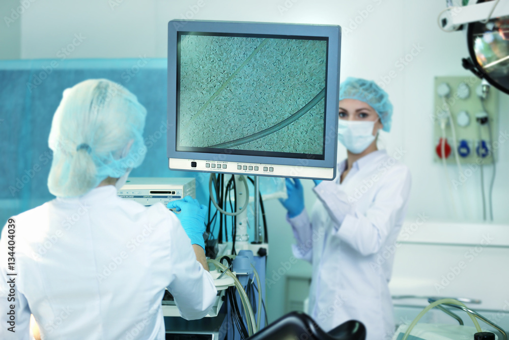 Φωτογραφία Young doctor working with medical equipment in operating room of modern clinic