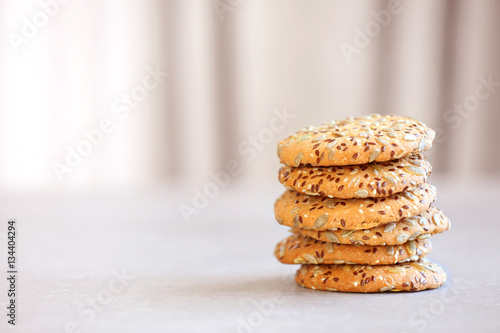 Delicious cereal cookies on blurred background