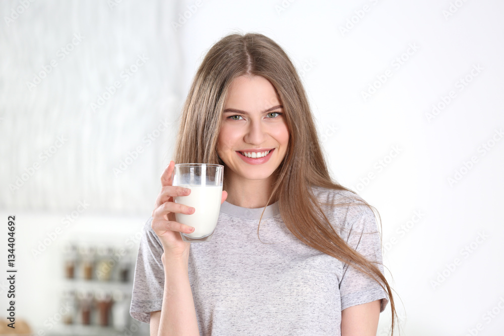 Beautiful young woman drinking milk at home Beautiful young woman drinking milk at home