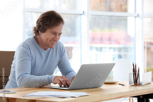 Mature man working with lap...