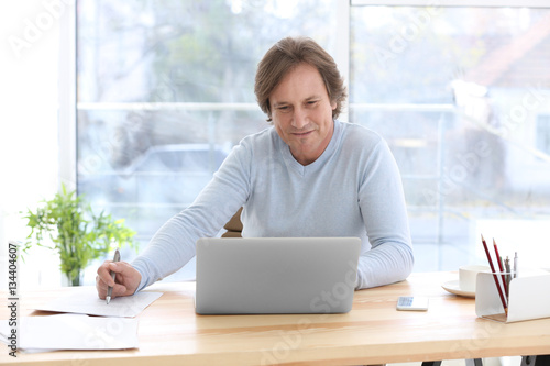 Mature man working in office
