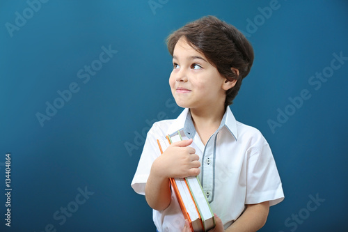 Cute little boy with books ...