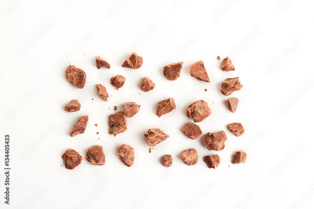 Milk chocolate morsels on white background Milk chocolate morsels on white background