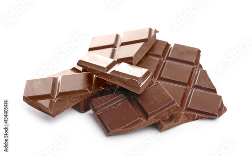 Broken dark chocolate pieces on white background