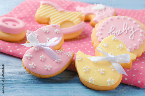 Baby cookies decorated with glaze on wooden background © Africa Studio
