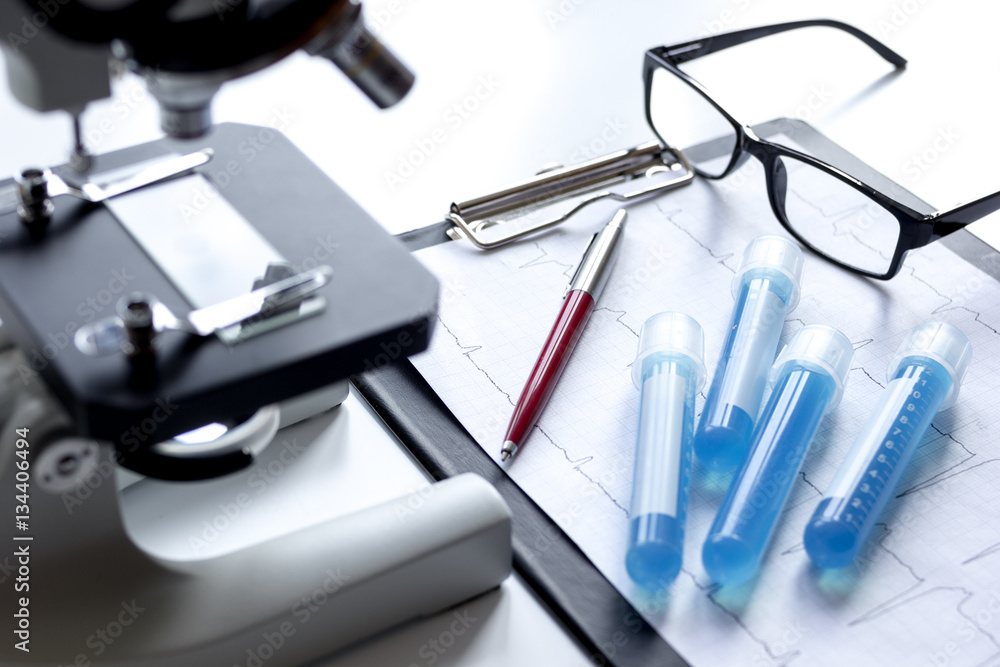 doctors desk with microscope and test tubes doctors desk with microscope and test tubes