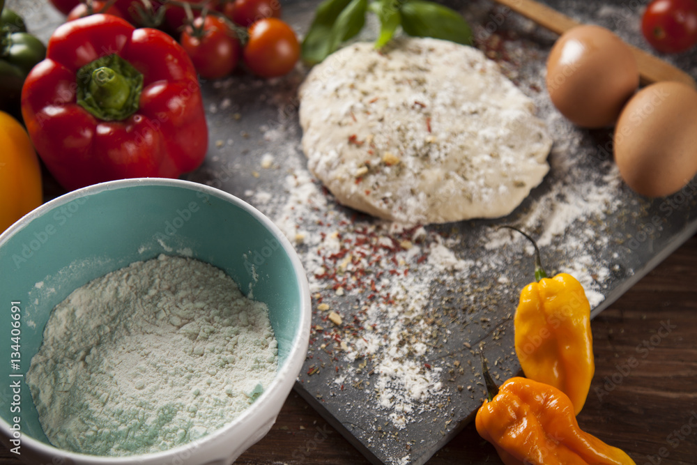 Fototapeta premium Preparing pizza with dough and tomato sauce