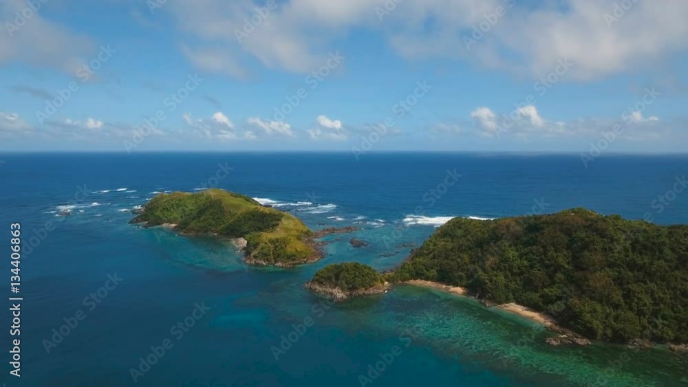 Aerial view:Tropical island with beach, mountains and the rainforest. Sea and the tropical island with rocks, beach and waves. Seascape: sky, clouds, rocks, ocean. 4K video. 4K video. Travel concept Aerial view:Tropical island with beach, mountains and the rainforest. Sea and the tropical island with rocks, beach and waves. Seascape: sky, clouds, rocks, ocean. 4K video. 4K video. Travel concept