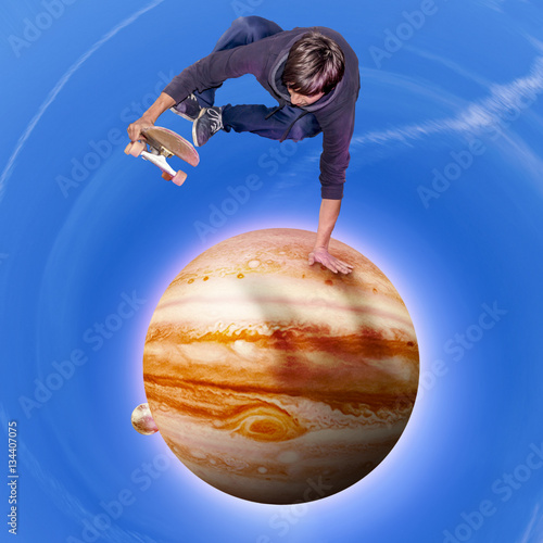 young skateboarder jumping over the jupiter planet aerial view