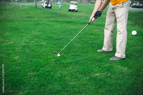 Back view of man on green grass golf field natural outdoors background