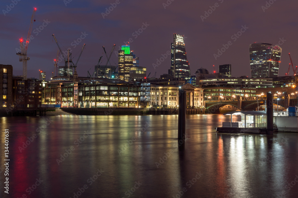 LONDON, ENGLAND - JUNE 18 2016: Night photo of Millennium Bridge, Thames River and  St. Paul Cathedral, London, Great Britain