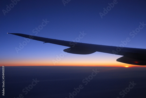 dawn light on the cloud under the airplane wing