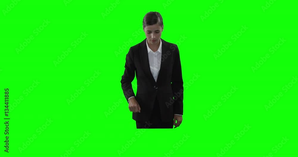 Beautiful businessman touching digital screen against green screen Beautiful businessman touching digital screen against green screen