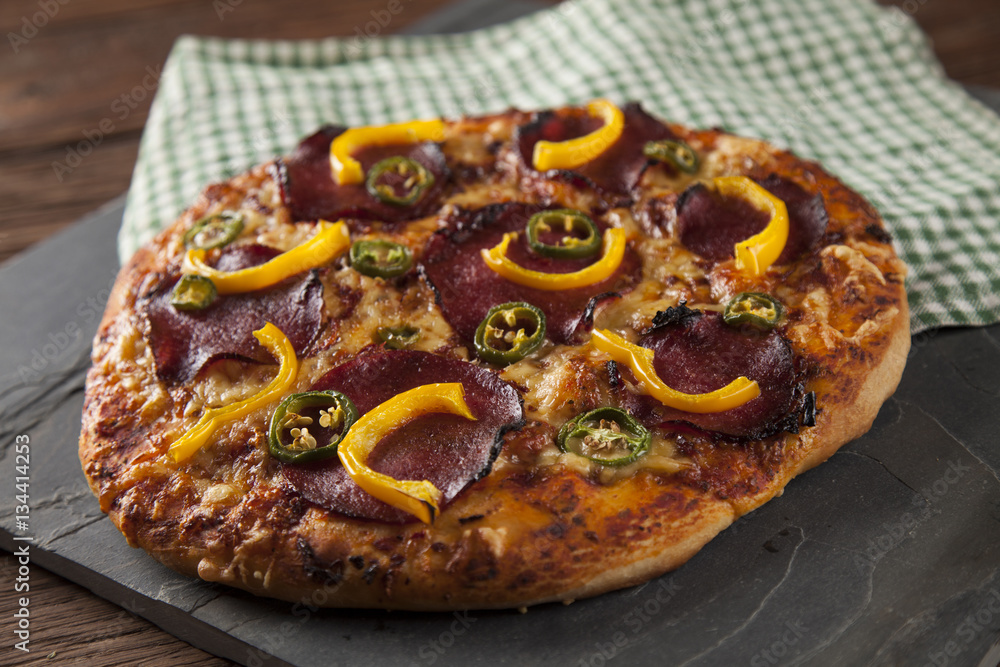 Delicious pizza served on wooden table Delicious pizza served on wooden table