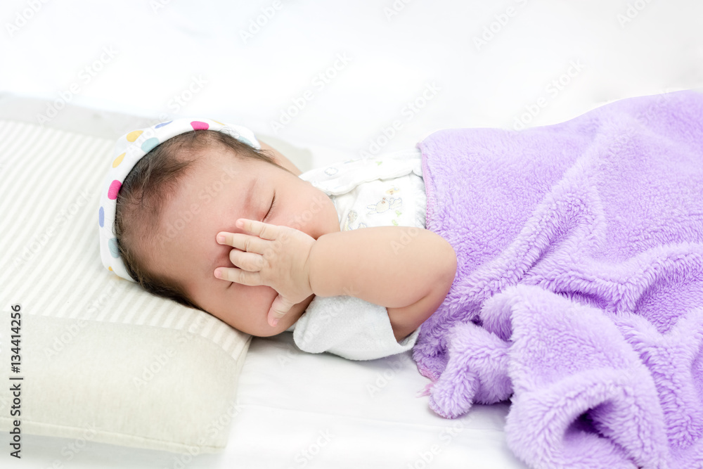 Portrait of adorable baby sleeping in hat on the bed Portrait of adorable baby sleeping in hat on the bed