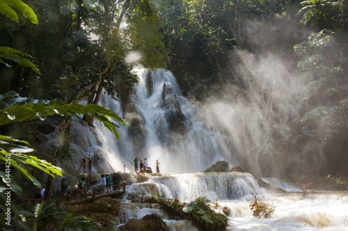 LUANG PRABANG, LAOS - OCTOBER 10: Unidentified tourists at the main waterfall at Kuang Si Waterfall near Luang Prabang, Laos on October 10, 2014.