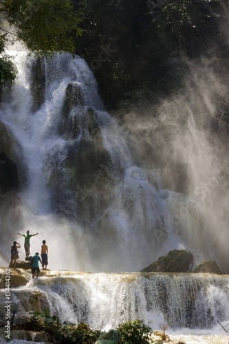 LUANG PRABANG, LAOS - OCTOBER 10: Unidentified tourists at the main waterfall at Kuang Si Waterfall near Luang Prabang, Laos on October 10, 2014. © Danaan