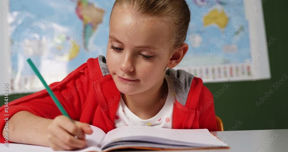 Slow motion of schoolgirl doing homework in classroom at school 4k Slow motion of schoolgirl doing homework in classroom at school 4k