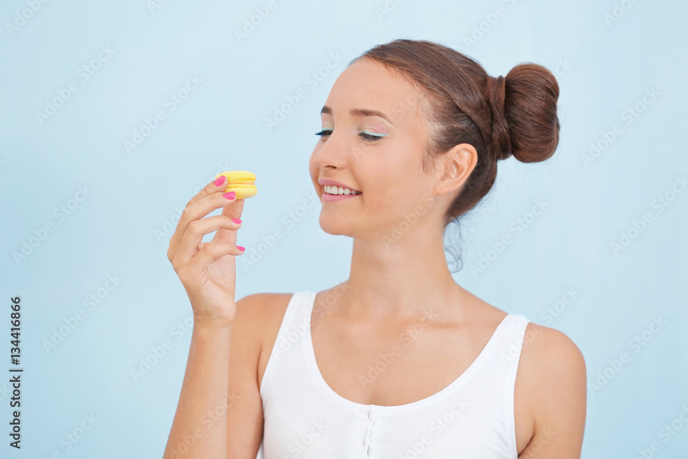 Cute girl with macaroon on light background Cute girl with macaroon on light background