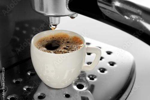 Coffee machine making espresso, closeup
