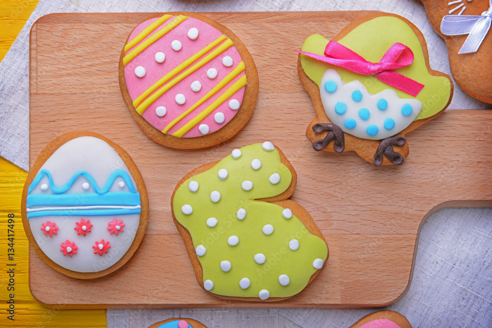 Colourful tasty Easter cookies on wooden board, closeup Colourful tasty Easter cookies on wooden board, closeup