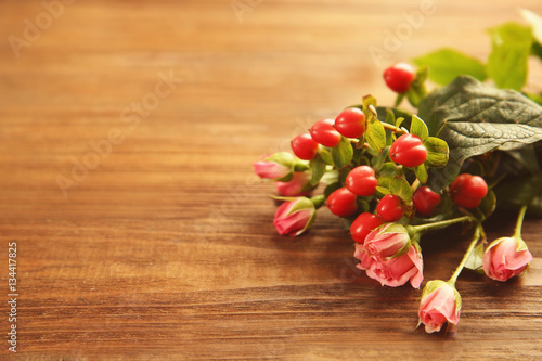 Bouquet of beautiful red roses on wooden background