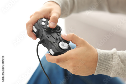 Teenager playing videogame at home, closeup © Africa Studio