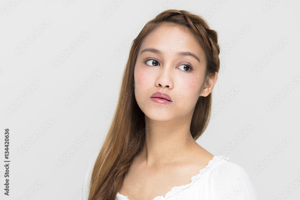 Portrait of beauty girl on blue background, half latina and half asian Portrait of beauty girl on blue background, half latina and half asian