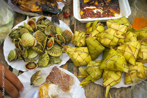 Assortment of Hanging Rice, Filipino Seafood and Picnic Foods on a Cebu Island Beach