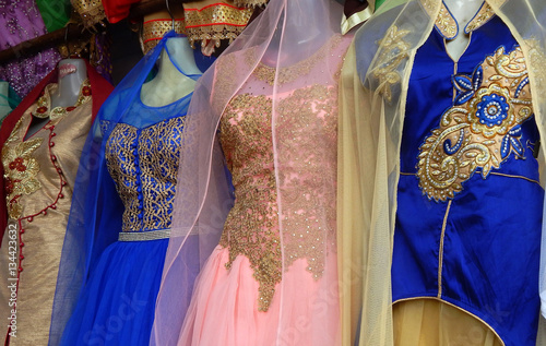 Mannequins dressed in latest traditional Indian fashion kept in front of retail clothes shop  photo