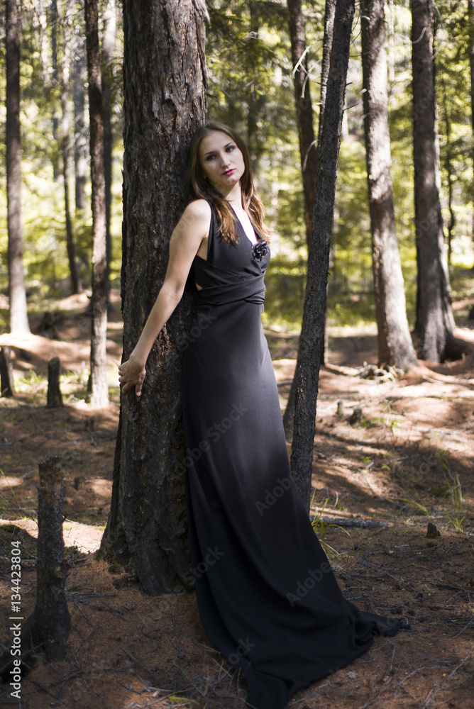 Beautiful young girl walking in a fairy forest. Beautiful young girl walking in a fairy forest.