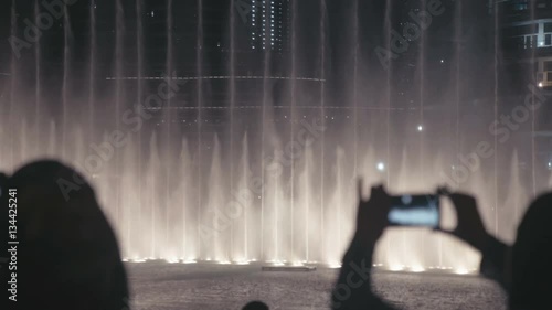 Wallpaper Mural UAE, 2017: Singing fountains in Dubai. Tourists and locals watch the show singing fountains and photographed on a mobile phone. Shooting on a mobile phone. Dancing Fountains. Torontodigital.ca