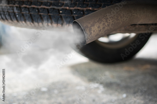 combustion fumes coming out of car exhaust pipe photo