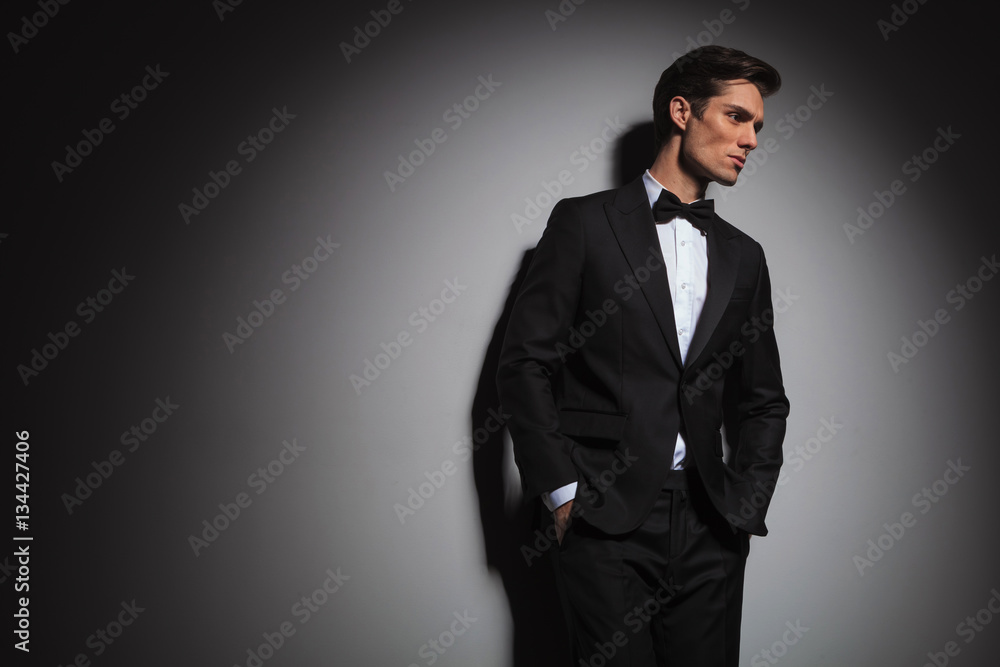 pensive elegant man wearing tuxedo looks away to side pensive elegant man wearing tuxedo looks away to side