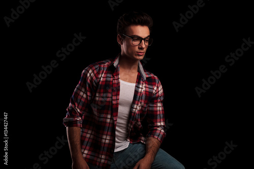 young sexy man in checkered shirt and glasses looking away