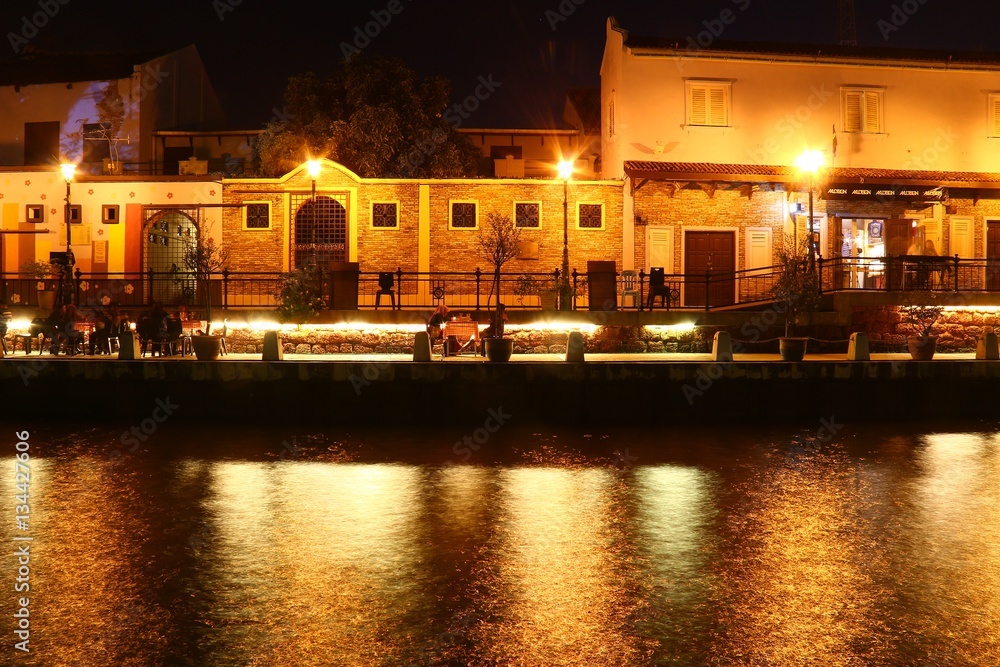 Malacca river at night with the light reflection in the water, Malaysia