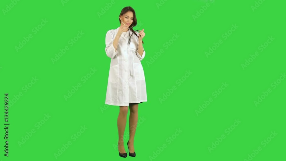 Funny female nurse playing with a stethoscope on a Green Screen, Chroma Key Funny female nurse playing with a stethoscope on a Green Screen, Chroma Key