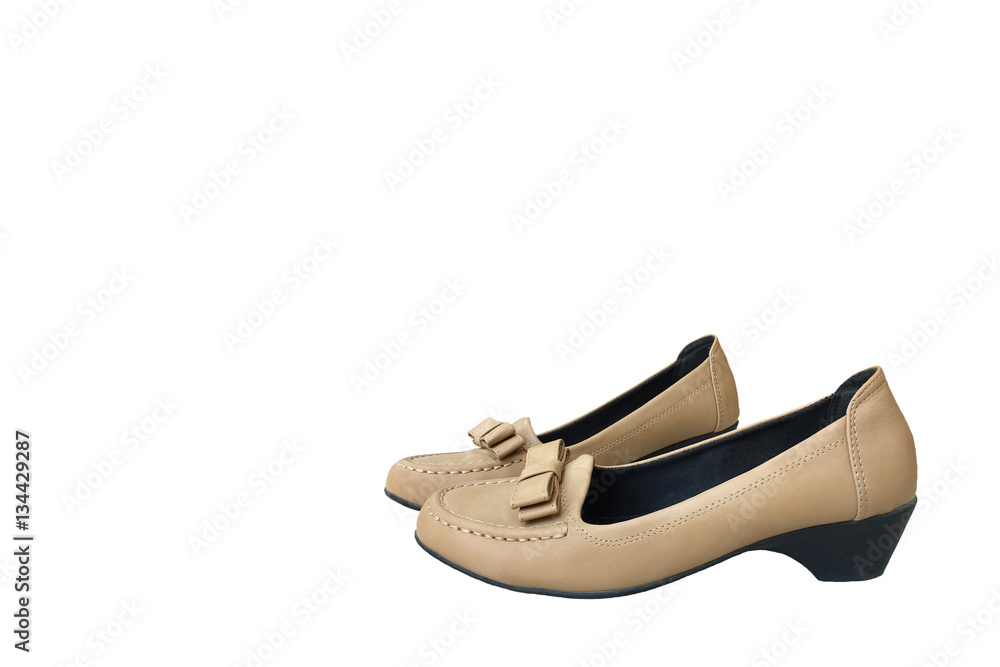 Naklejka premium Female brown shoes on a white background.