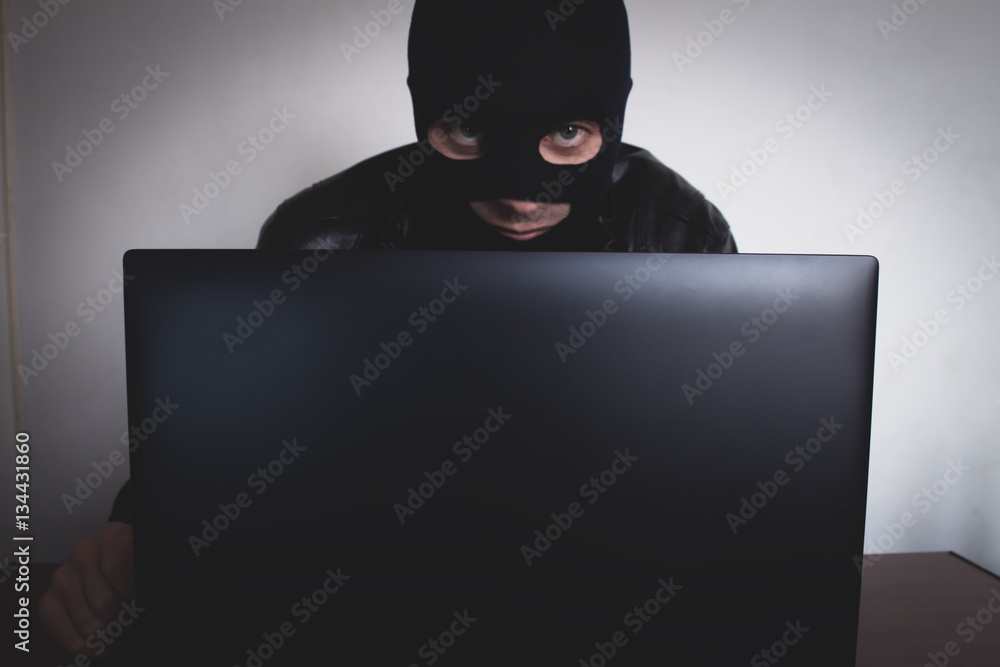 Hacker with computer. Hacker with computer.