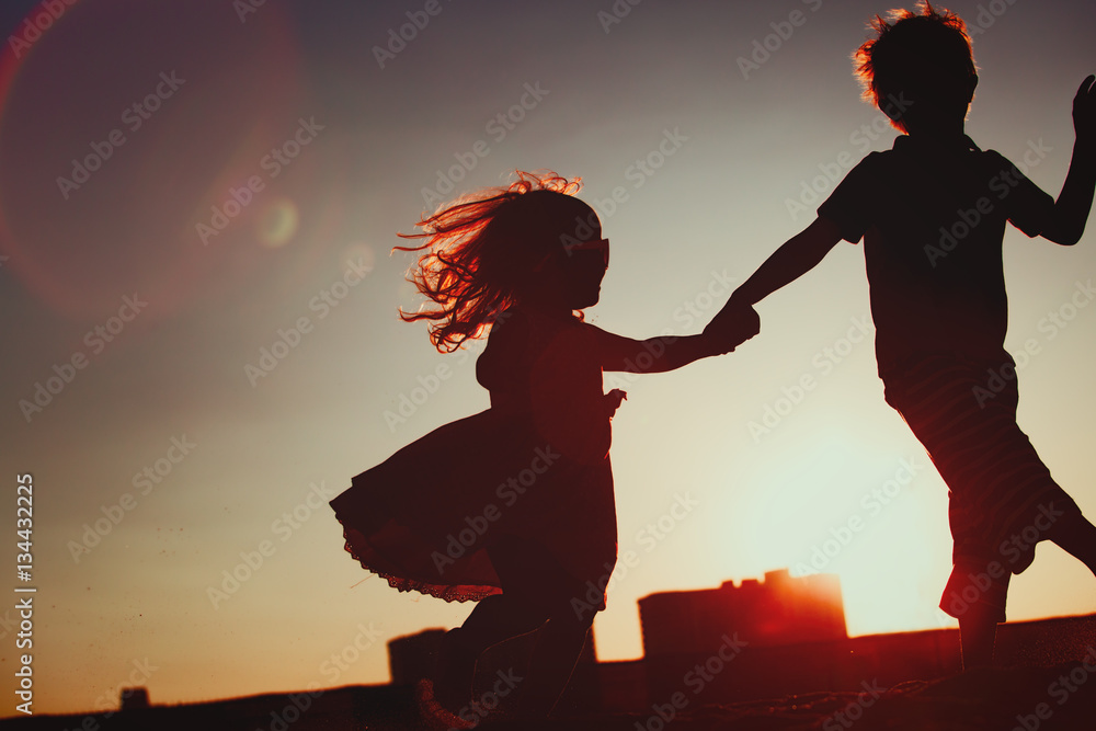 little boy and girl play at sunset sky Stock Photo | Adobe Stock