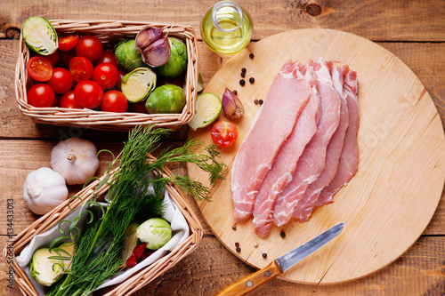 Slices of raw pork meat and vegetables 