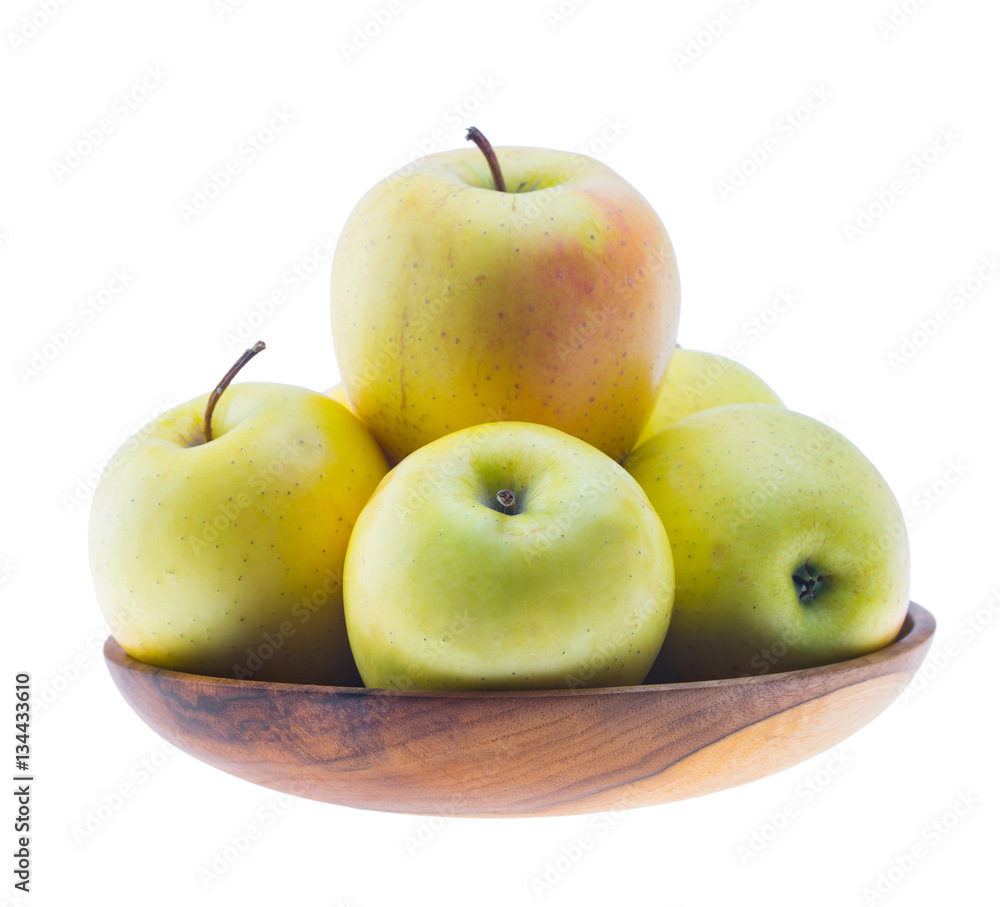 big ripe juicy yellow golden apples in wooden bowl isolated on white background big ripe juicy yellow golden apples in wooden bowl isolated on white background